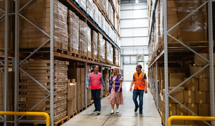 Workers walking through warwheouse 